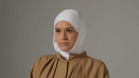 Studio-Portrait-Of-Muslim-Woman-Wearing-Hijab-Against-Plain-Background